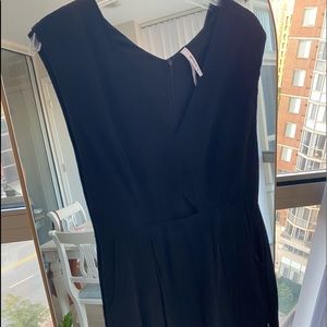 RCVA mini black dress with deep v and triangle cut out above waist. Size M